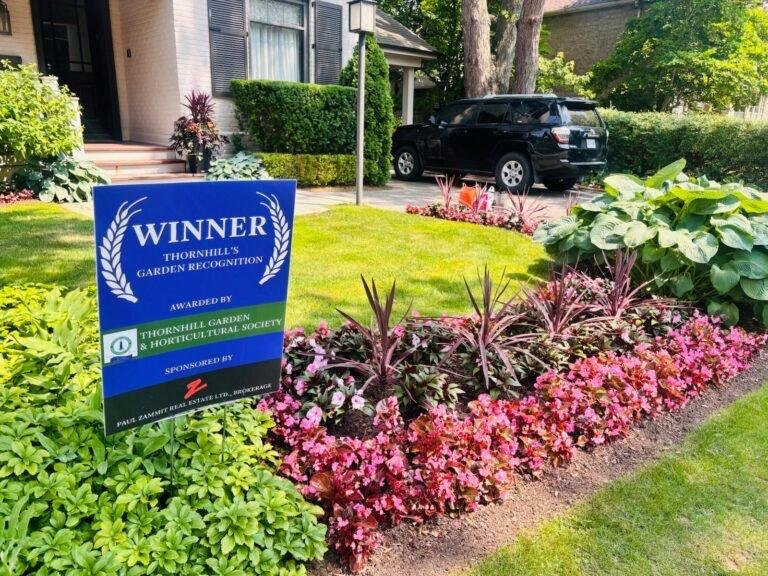 Award sign beside a planted front-garden bed